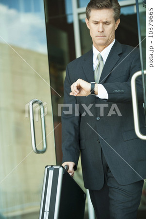 Businessman looking at watch Businessman looking at watch 10379665