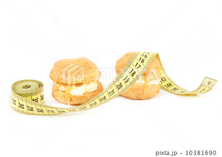 concept of slimming, caramel cakes with measuring tape concept of slimming, caramel cakes with measuring tape 10381690