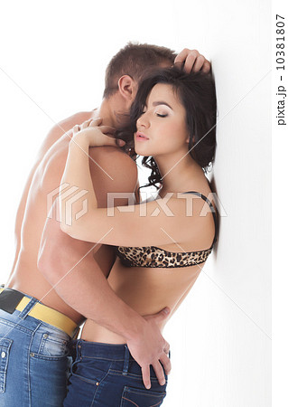 Passionate young lovers embracing in studio 10381807