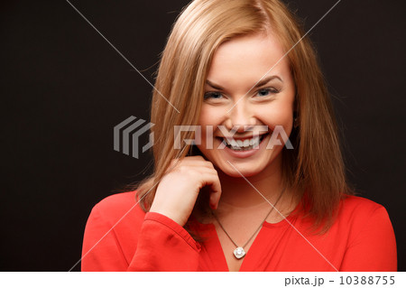 smiling woman in red blouse 10388755