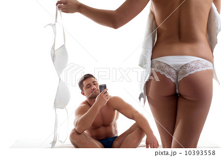 Glad young man taking snapshot of sexy girl 10393558