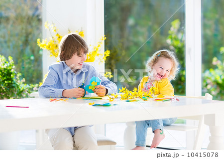 Two kids, happy teenager boy and his cute toddler sister, having 10415078
