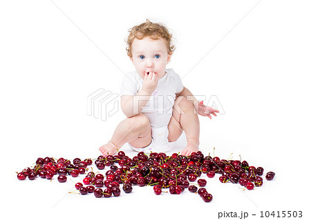 LIttle baby playing with red cherry, on white background LIttle baby playing with red cherry, on white background 10415503