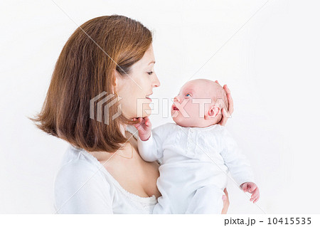 Smiling young mother holding her newborn baby 10415535