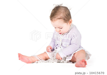 Cute baby girl playing with pearls 10415670