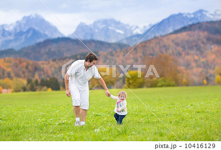 Young happy father playing with his baby daughter in a beautiful 10416129