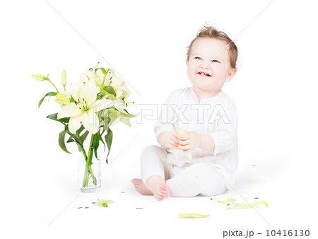 Funny little baby playing with lily flowers, on white 10416130