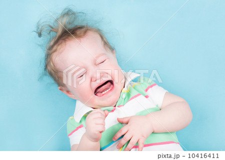 Sweet crying baby on a blue blanket 10416411