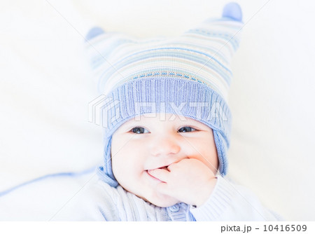Little baby in a funny blue hat on white background 10416509