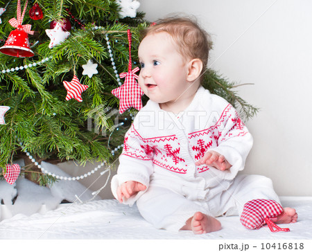 Cute funny baby girl playing under a Christmas tree 10416818