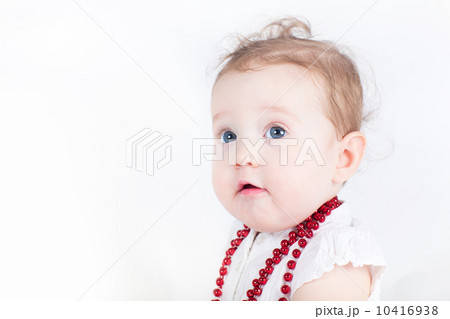 Beautiful baby girl with a red necklace Beautiful baby girl with a red necklace 10416938