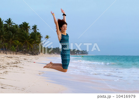 Young beautiful woman jumping on a tropical beach 10416979