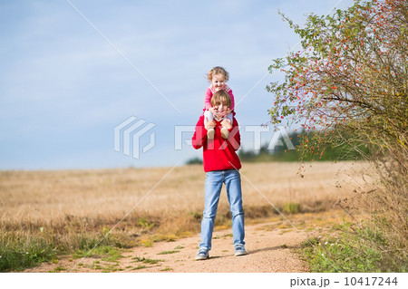 Happy laughing brother and his baby sister playing together in a 10417244