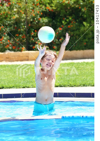 Little boy playing with a ball in a swimming pool Little boy playing with a ball in a swimming pool 10417453