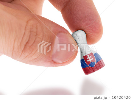 Hand holding wooden pawn, flag painting, selective focus Hand holding wooden pawn, flag painting, selective focus 10420420