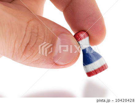 Hand holding wooden pawn, flag painting, selective focus Hand holding wooden pawn, flag painting, selective focus 10420428