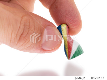 Hand holding wooden pawn, flag painting, selective focus Hand holding wooden pawn, flag painting, selective focus 10420433