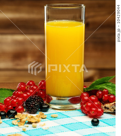 Healthy breakfast with fresh orange juice on tablecloth in wooden rural interior Healthy breakfast with fresh orange juice on tablecloth in wooden rural interior 10429044