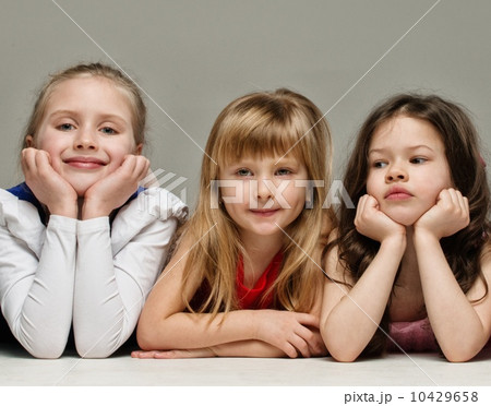 Three little girls isolated on grey background 10429658