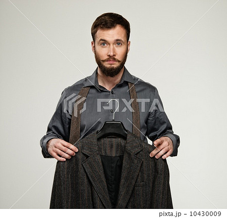 Handsome man with beard choosing jacket Handsome man with beard choosing jacket 10430009