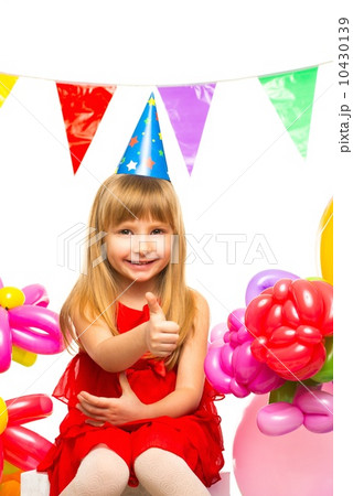 Little girl in red dress sitting on gift boxes Little girl in red dress sitting on gift boxes 10430139