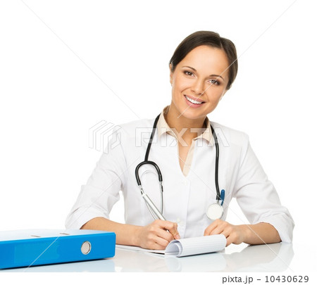Young positive brunette doctor woman behind table taking notes Young positive brunette doctor woman behind table taking notes 10430629