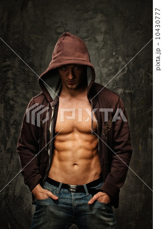 Stylish man with muscular torso wearing hoodie Stylish man with muscular torso wearing hoodie 10430777