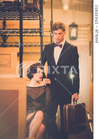 Beautiful vintage style couple inside retro train coach Beautiful vintage style couple inside retro train coach 10430901