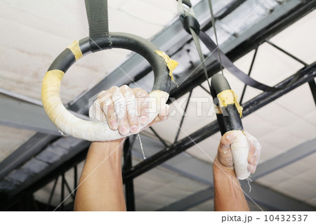 Human hanging in Gymnastic Rings. Focus on the right hand. 10432537