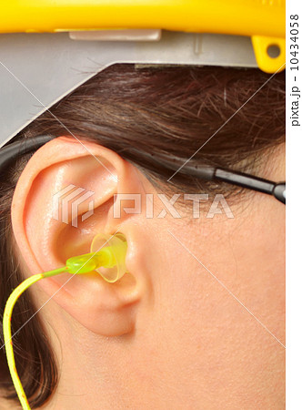 yellow earplug into the ear yellow earplug into the ear 10434058