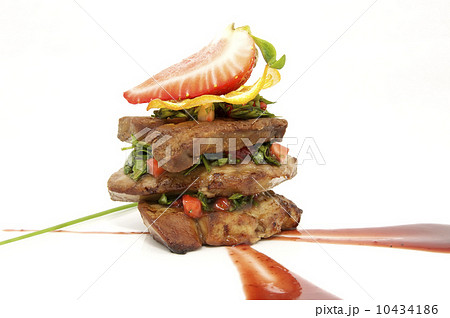 Roast goose liver is decorated with greens and strawberries 10434186