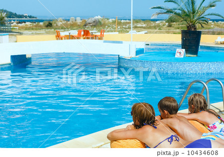 Mother with her children near swimming pool. 10434608