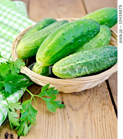 Cucumbers in wicker basket on board Cucumbers in wicker basket on board 10438876