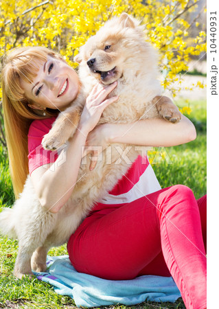 Portrait of a woman with her dog outdoors 10440931