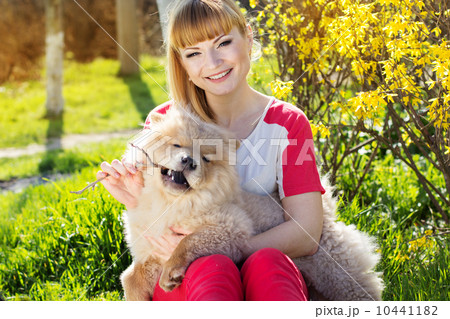 Portrait of a woman with her dog outdoors Portrait of a woman with her dog outdoors 10441182