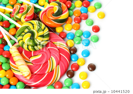 Colorful spiral lollipop with chocolate coated candy . 10441520