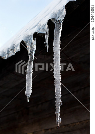 Icicles hang down from a building roof Icicles hang down from a building roof 10446892