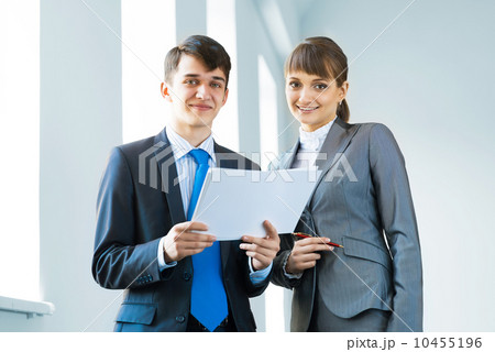 two business partners discussing reports two business partners discussing reports 10455196