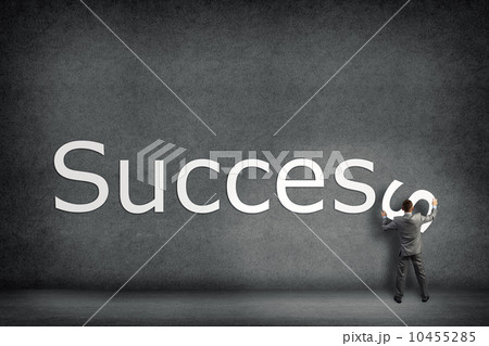Businessman collects on the wall the word success 10455285