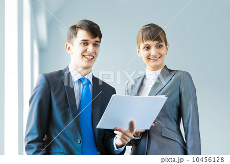 two business partners discussing reports 10456128