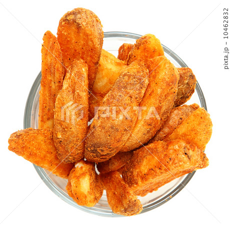 Spicy Potato Wedges in Glass Bowl Over White Spicy Potato Wedges in Glass Bowl Over White 10462832