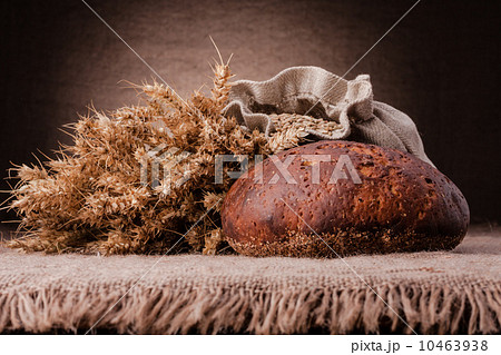 Loaf of bread and rye ears still life Loaf of bread and rye ears still life 10463938