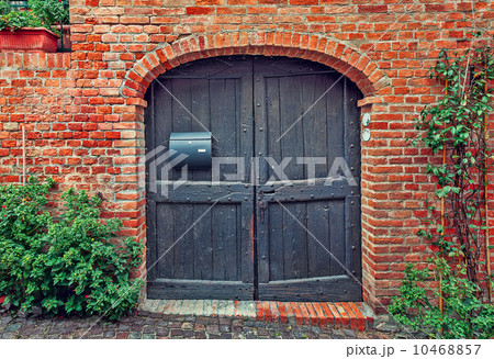 Wooden door and red brick wall. 10468857