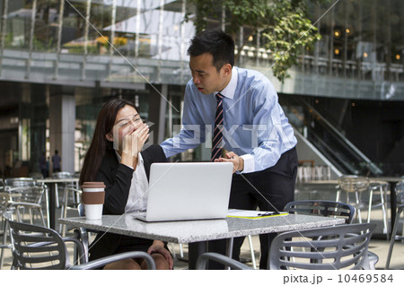 Frustrated Asian boss scolding his employee over her work Frustrated Asian boss scolding his employee over her work 10469584
