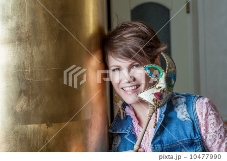 Cheerful pretty middle-aged woman posing with mask 10477990