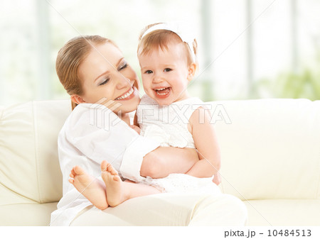 happy family. Mother and baby daughter plays, hugging, kissing happy family. Mother and baby daughter plays, hugging, kissing 10484513