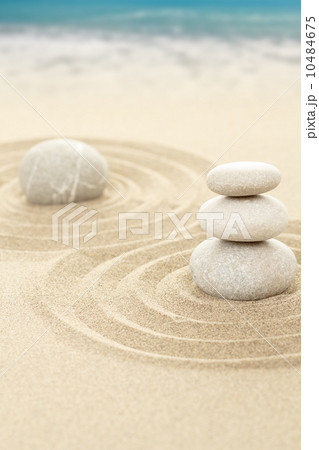 Balance zen stones in sand with sea in background Balance zen stones in sand with sea in background 10484675