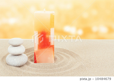 Balance zen stones and candle in sand on bokeh Balance zen stones and candle in sand on bokeh 10484679