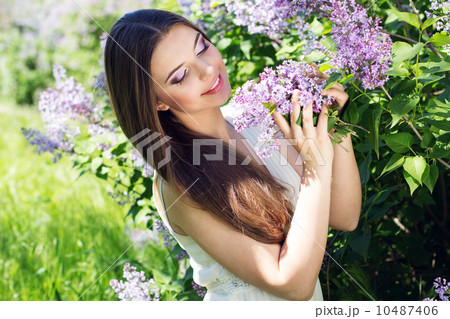 Beautiful girl with a lilac flowers 10487406