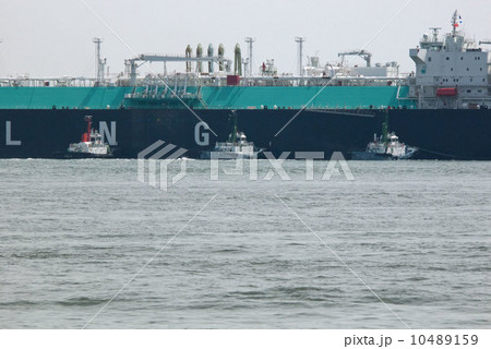 力を合わせて大型タンカーを動かすタグボート 10489159